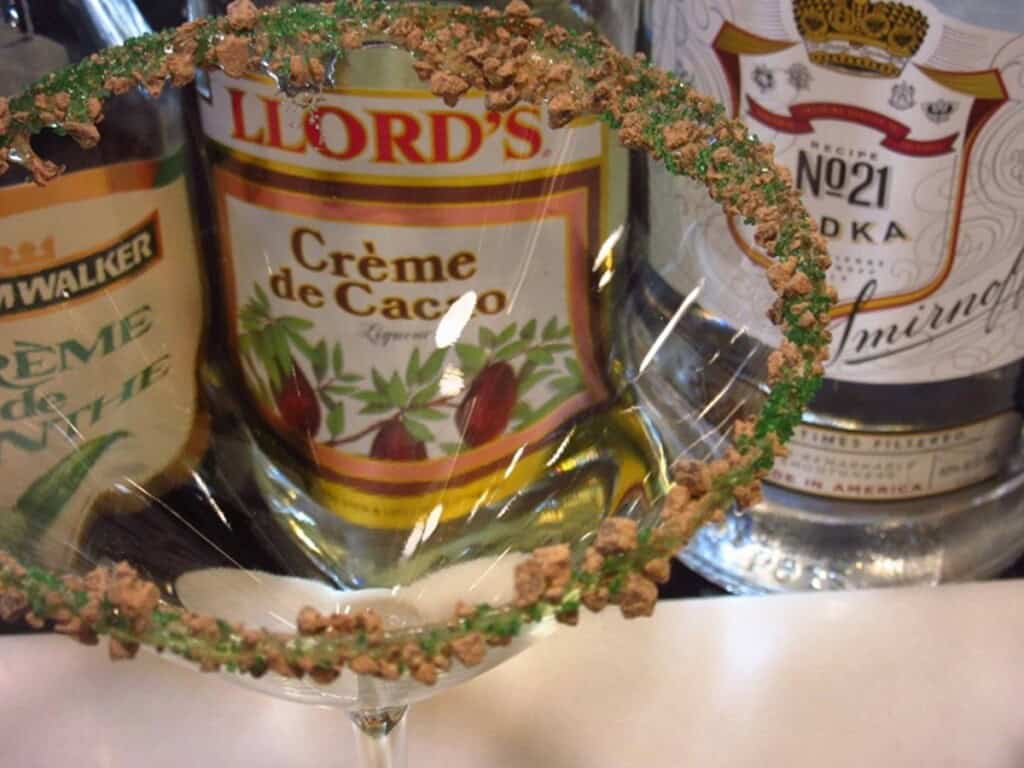 A green sugar and cocoa rimmed martini glass.