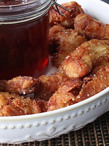 Golden brown Japanese Fried Chicken Nuggets in a white bowl.