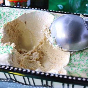 An ice cream scoop in a container of no churn Irish coffee ice cream.