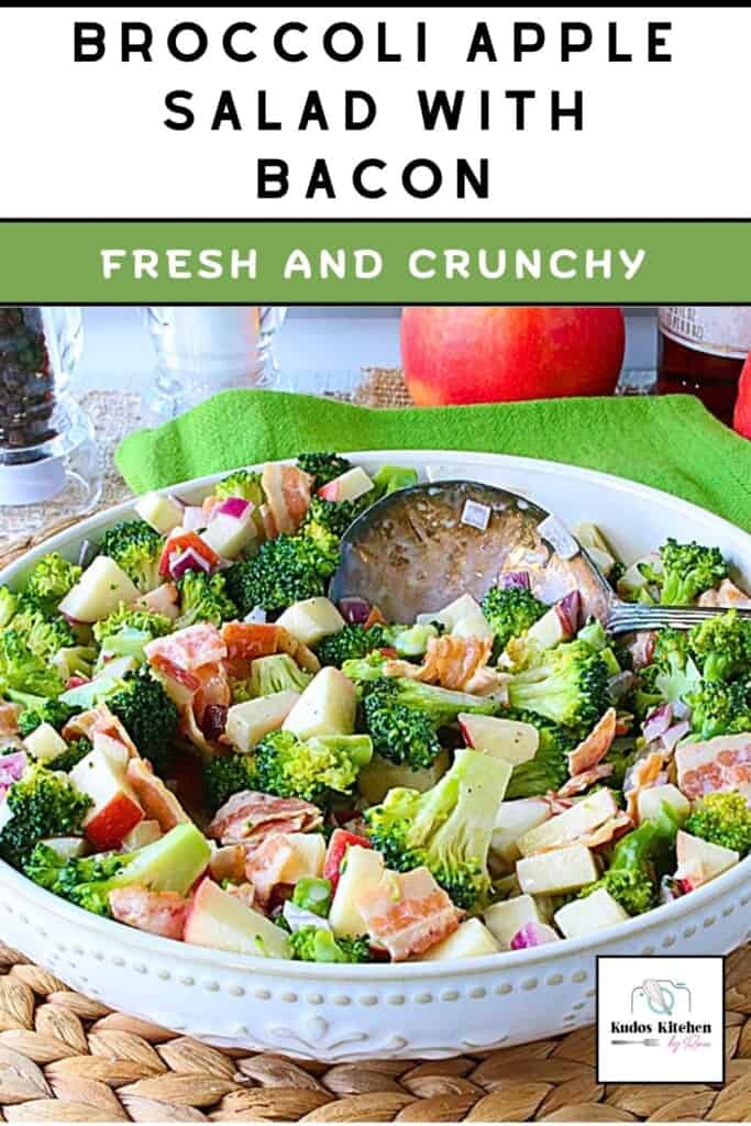 Bright green broccoli florets mixed with apple and bacon in a white serving bowl.