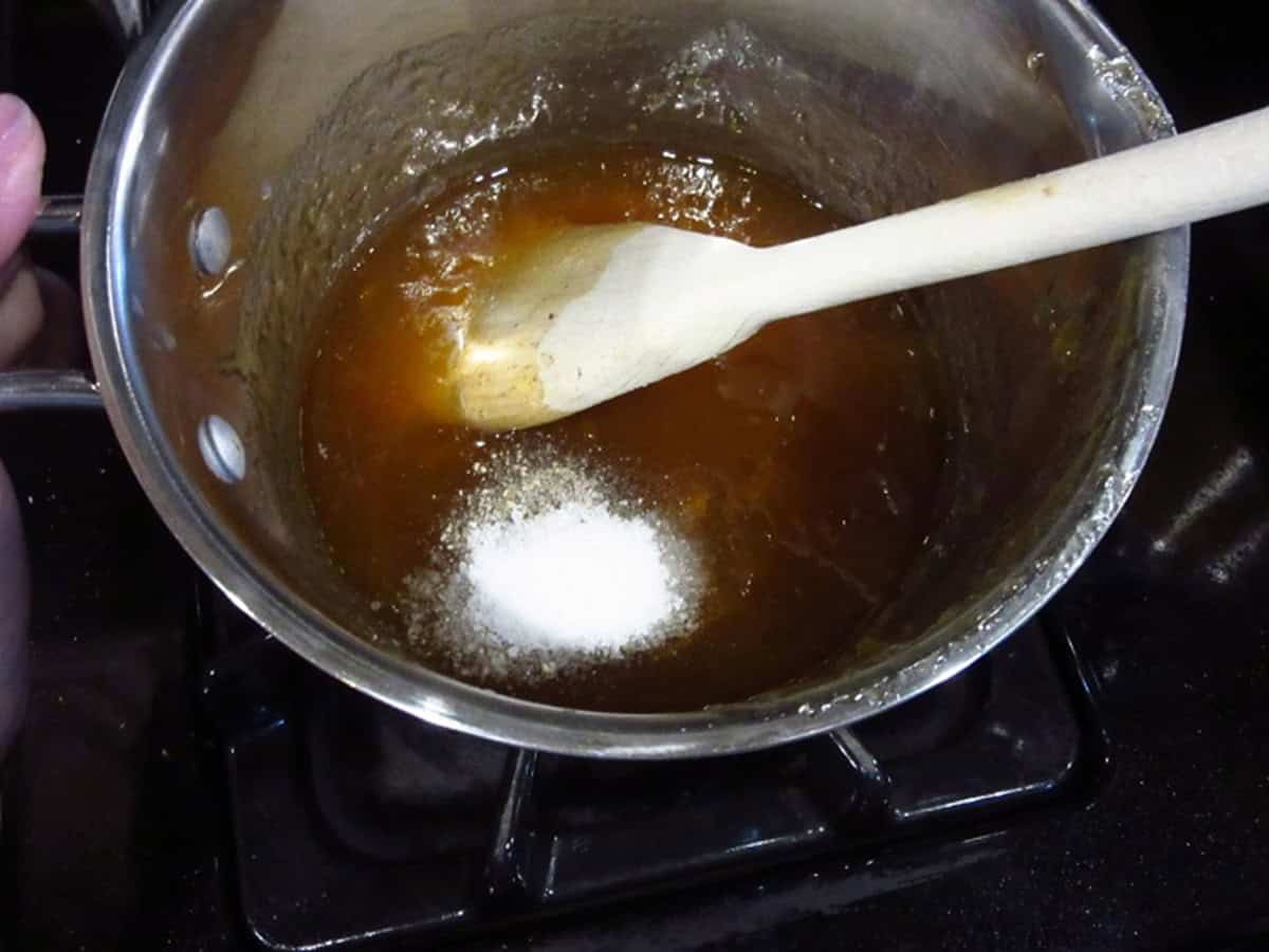 Salt and pepper in a saucepan with apricot glaze.