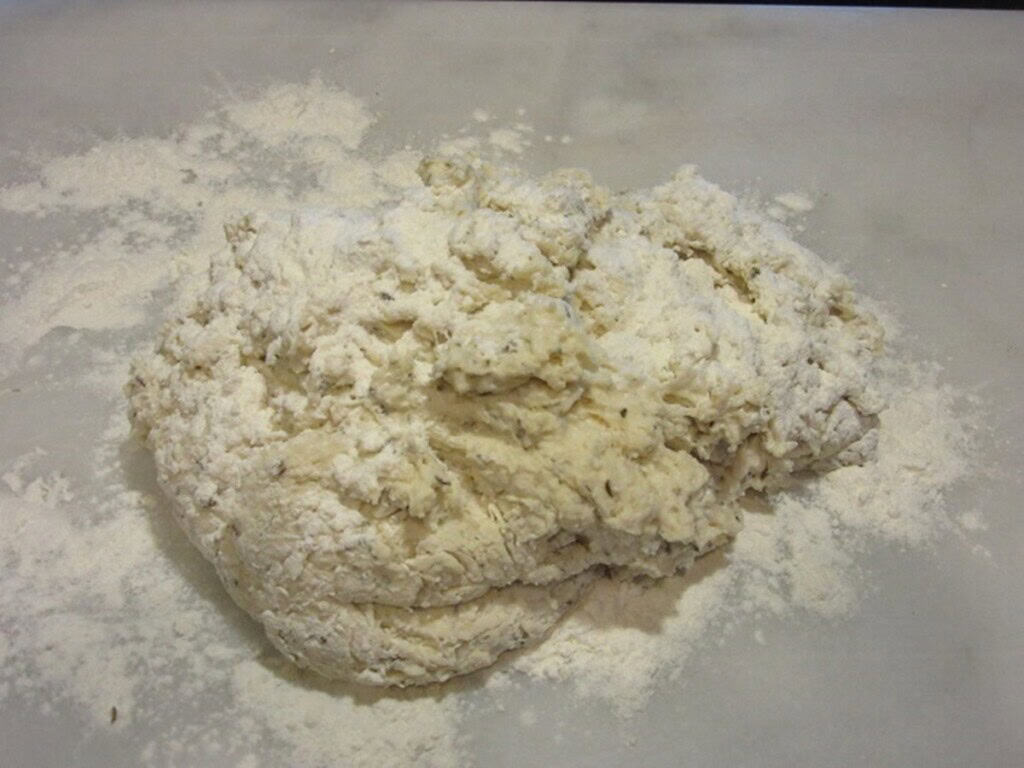 Flour sprinkled on top of Irish soda bread dough before kneading.