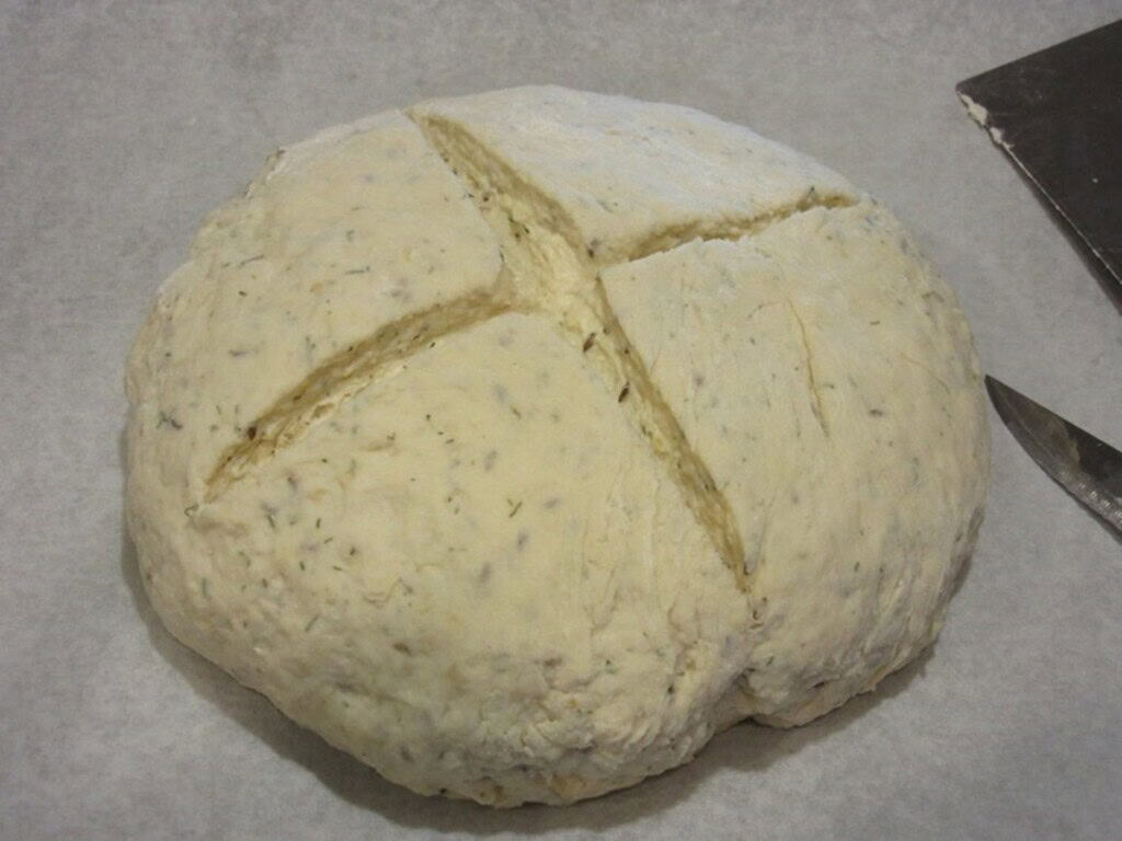 A cross cut on the top of an unbaked loaf of Irish soda bread.