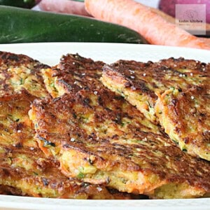 Delicious golden brown zucchini carrot fritters on a platter.