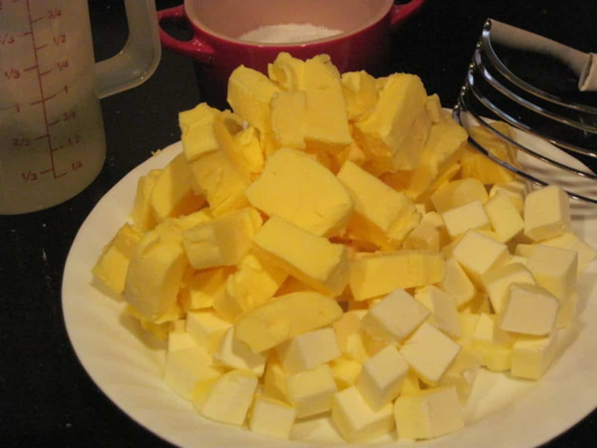 Cubed cold butter and shortening on a paper plate.