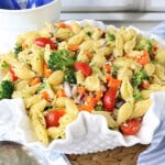 A fluted white bowl filled with Oil and Vinegar Veggie Pasta Salad.