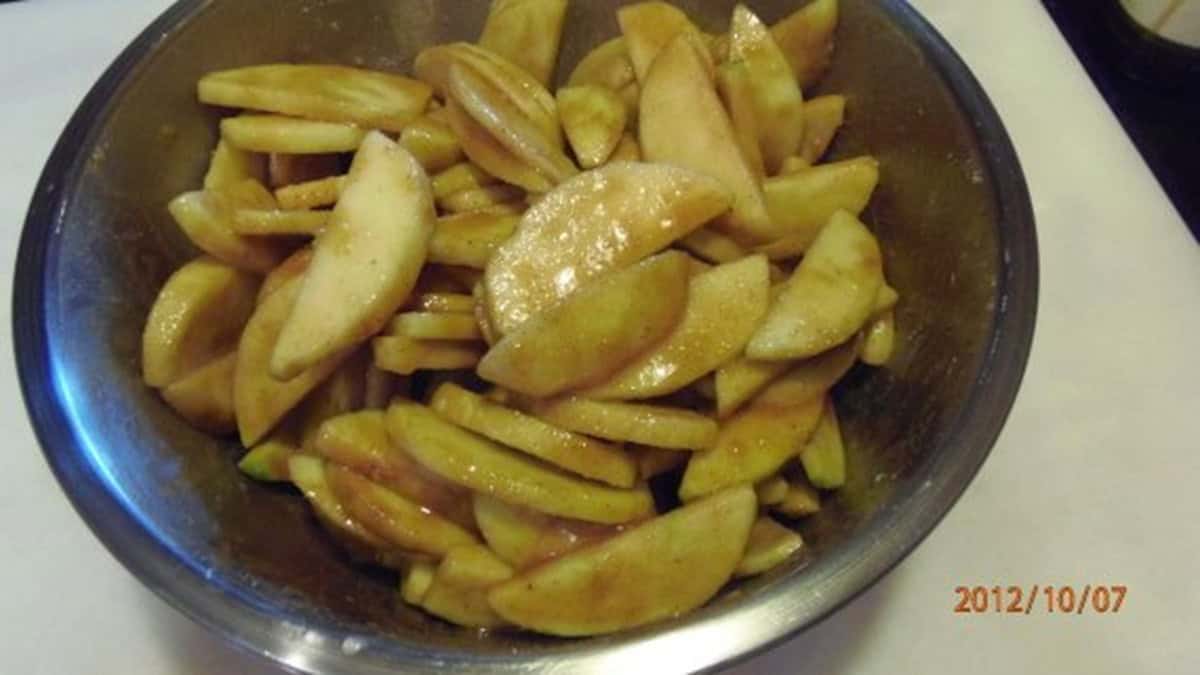 Sliced apples with spices in a bowl.
