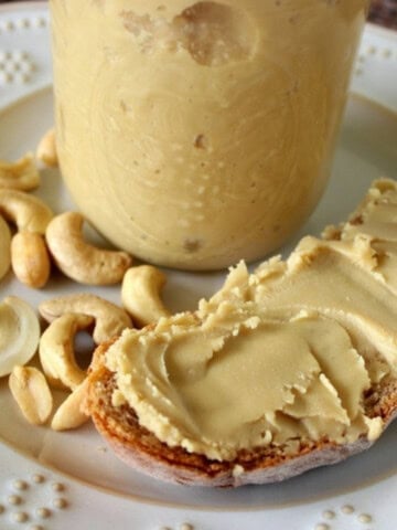 Delicious looking homemade peanut and cashew butter on a crusty slice of bread.