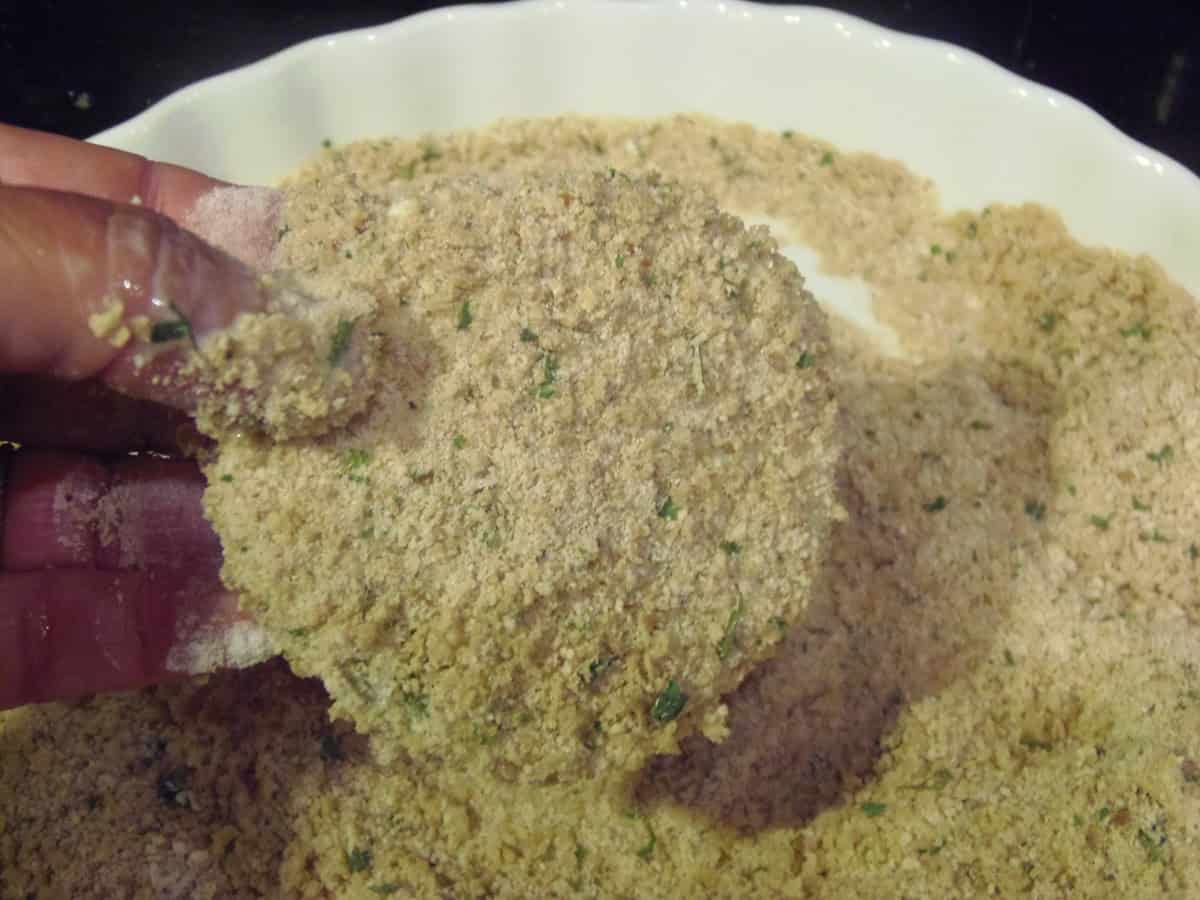 A crumb coated green tomato slice before frying.