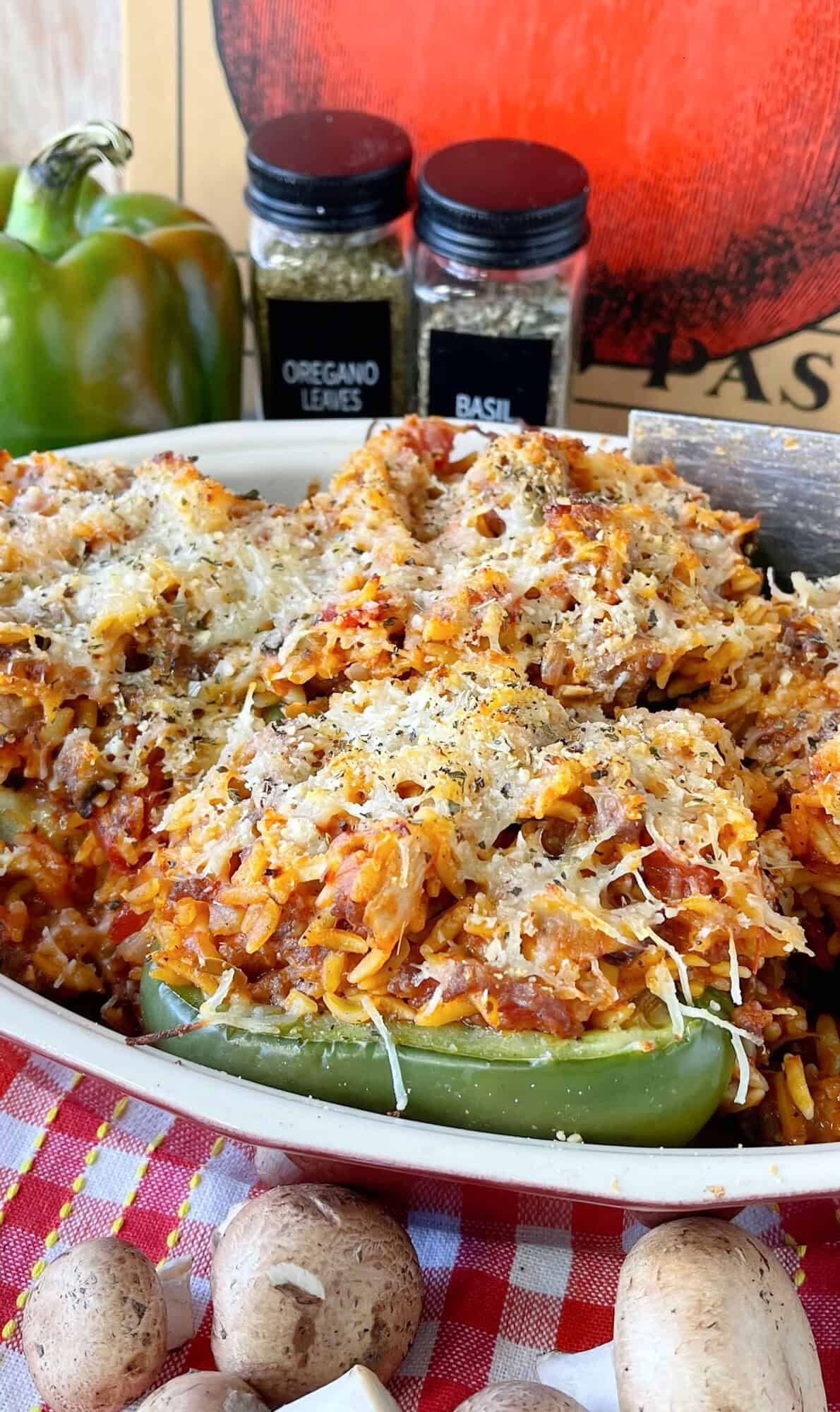 Cheesy topped Italian Stuffed Bell Peppers in a casserole dish.