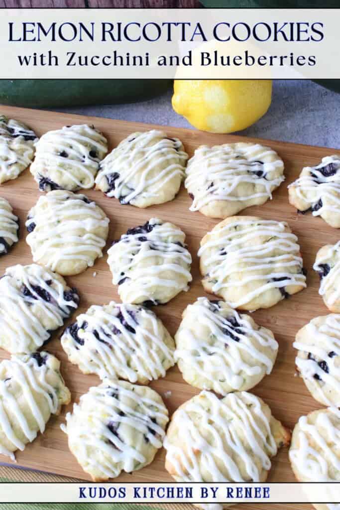 A bunch of lemon ricotta cookies on a wooden board.