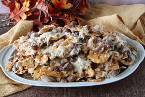 A fall scene with a platter of German Pretzel Chip Nachos as the focus point.