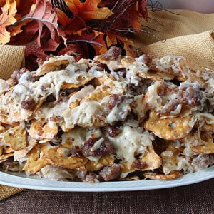 A platter piled high with German Pretzel Chip Nachos and bratwurst.