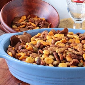 A big blue bowl filled with a delicious looking crunchy sesame seed stick snack mix.