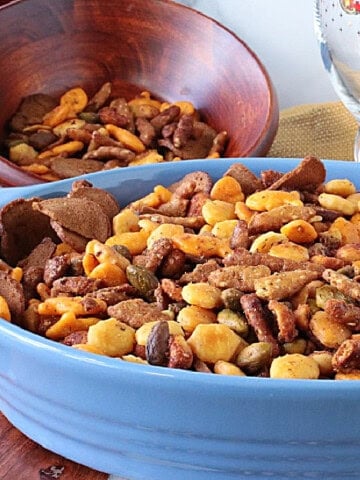 A big blue bowl filled with a delicious looking crunchy sesame seed stick snack mix.