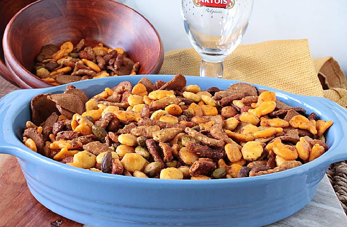 Lots of crunchy homemade sesame seed snack mix in a large bowl in the forefront and small brown bowl in the background.