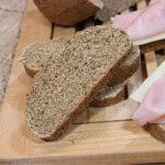 The inside texture of Homemade Rye Bread with Dill on a wooden cutting board.