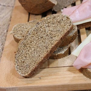 The inside texture of Homemade Rye Bread with Dill on a wooden cutting board.
