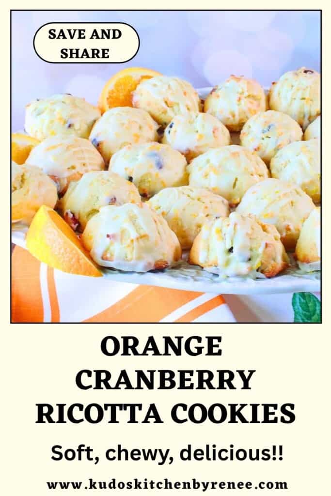 Soft, glazed, orange cranberry ricotta cookies piled high on a plate.