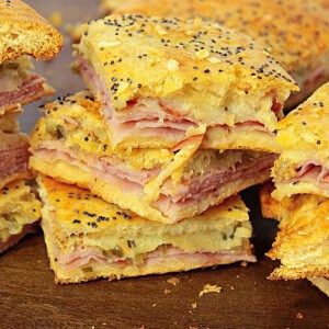 A yummy looking stack of ham and cheese appetizer squares made with crescent rolls.