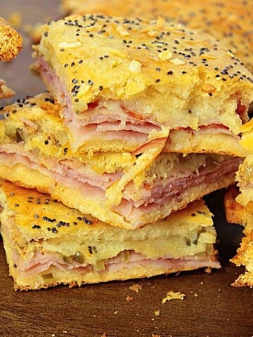 A yummy looking stack of ham and cheese appetizer squares made with crescent rolls.