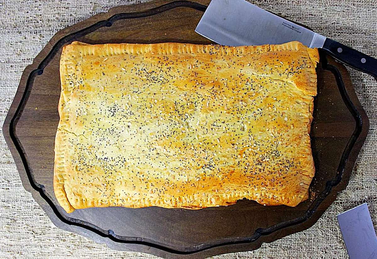 A crescent ham and cheese appetizer sandwich before cutting into slices.