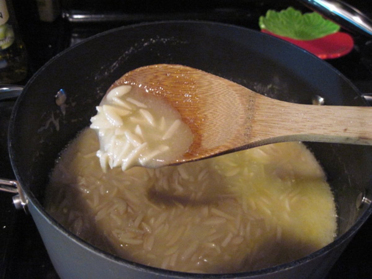 A wooden spoon showing the beginning stages of making almond butter toffee.