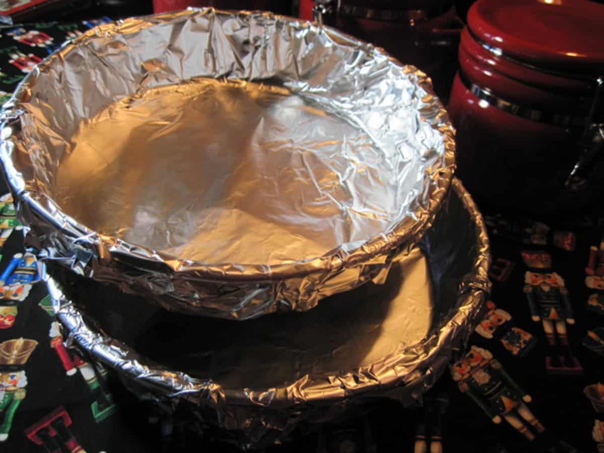 Two stacked, foil lined round cake pans.