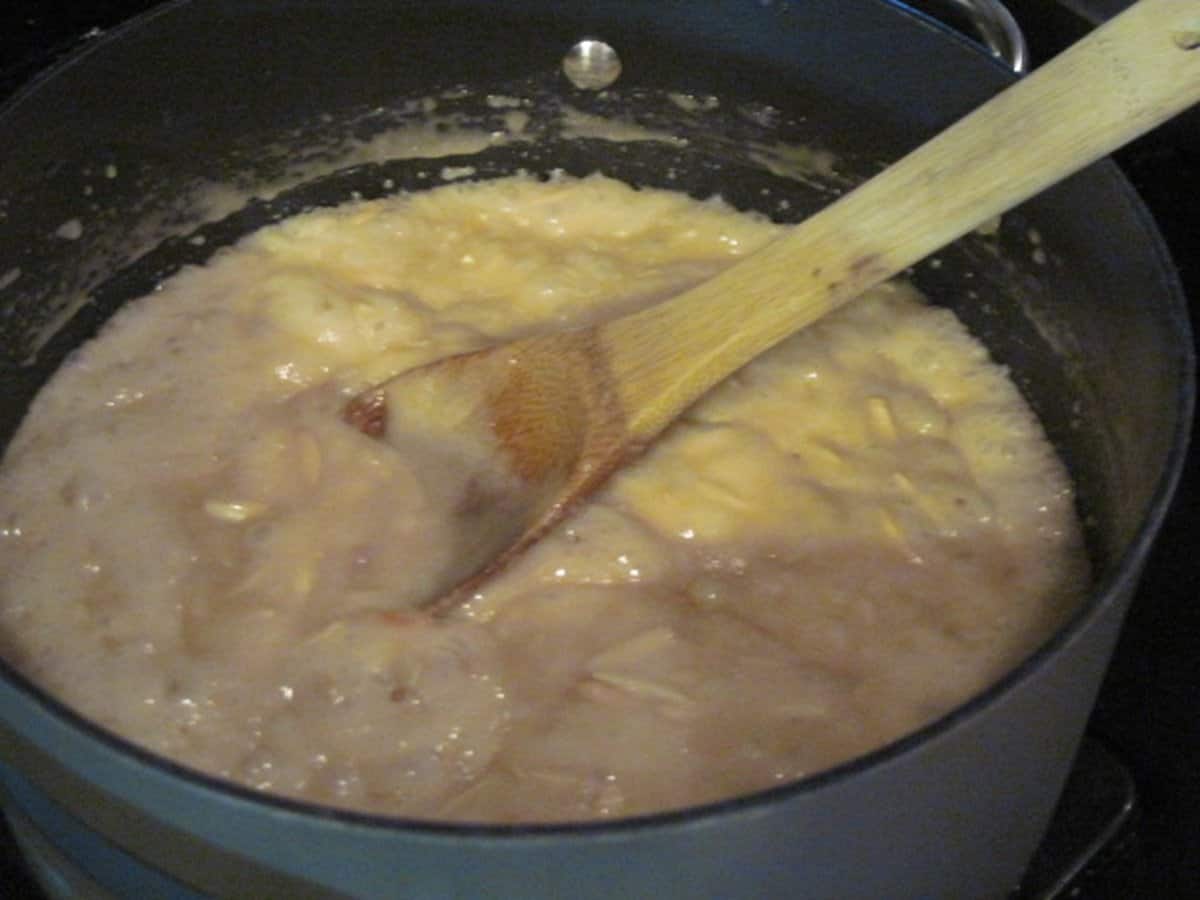 A light colored bubbling toffee in a saucepan.