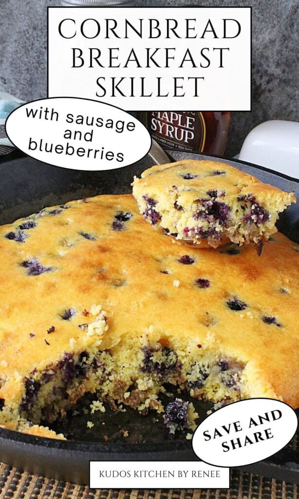 A cast iron skillet with a golden brown cornbread breakfast with sausage and blueberries.