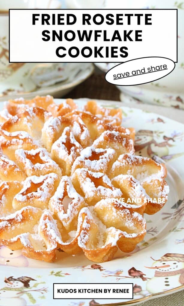 A powdered sugar coated fried rosette snowflake cookie on a snowman plate for the winter.