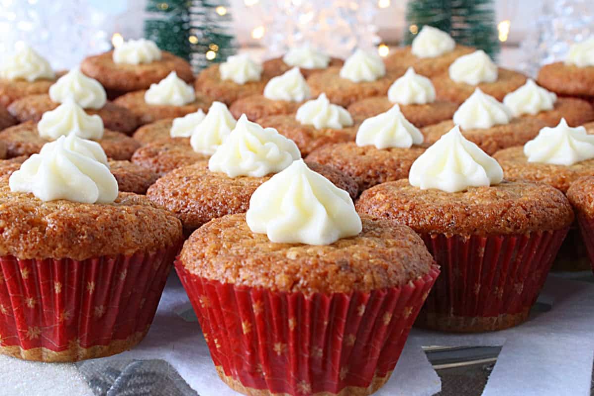 Red mini muffin cup liners filled with baked holiday nut cup cookies on a platter.