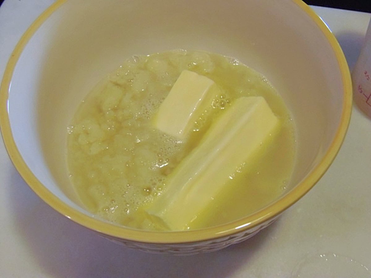 Melting butter in a bowl with hot water.