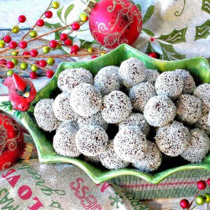 Festive holiday truffles covered in white nonpareils in a cute holly berry bowl.