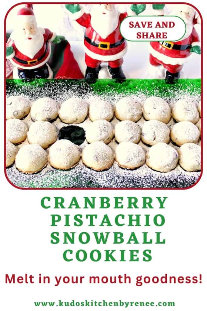A green glass Christmas plate lined up with powdered sugar covered snowball cookies.