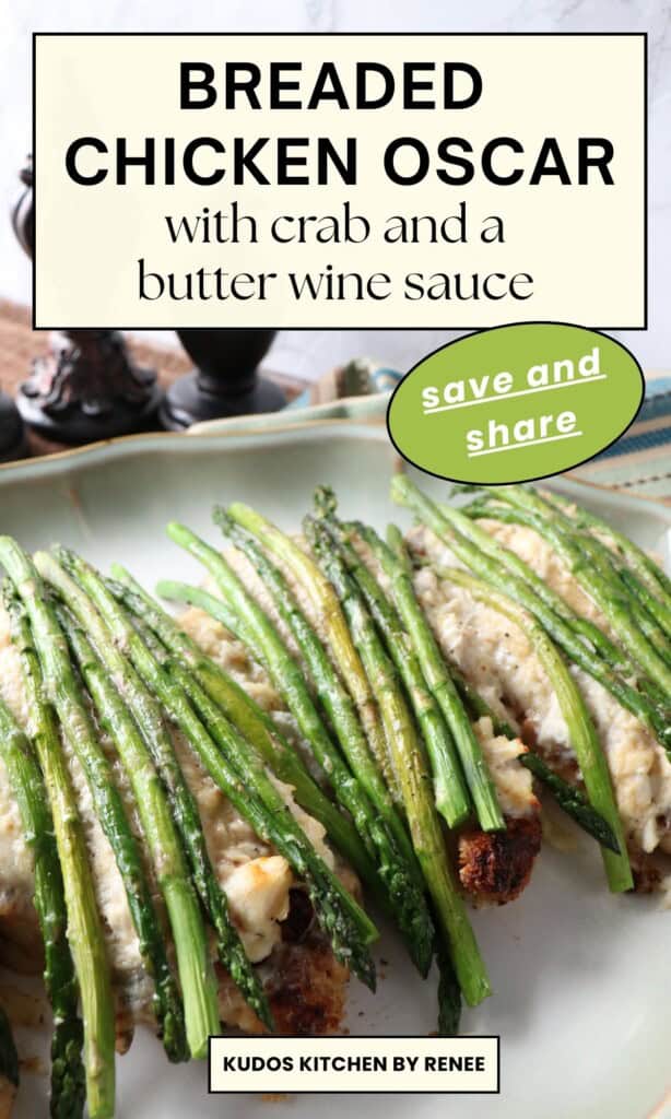 A beautiful breaded chicken Oscar on a plate topped with a pile of crab meat, asparagus, and cheese.