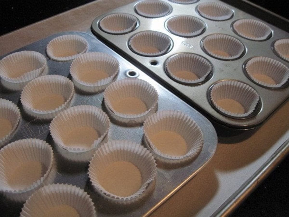 Two mini muffin cup tins with paper liners inserted.