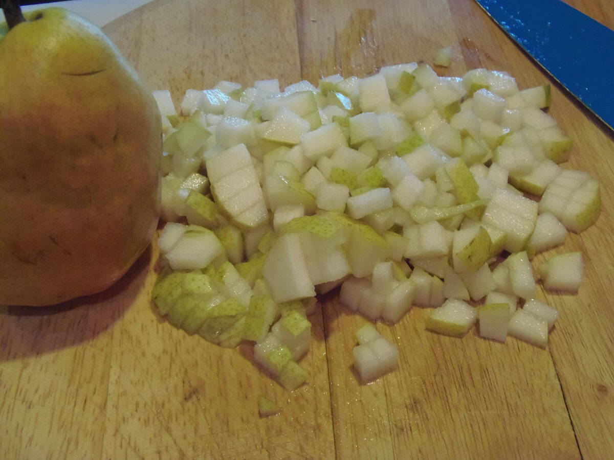 Diced pears on a wooden cutting board.