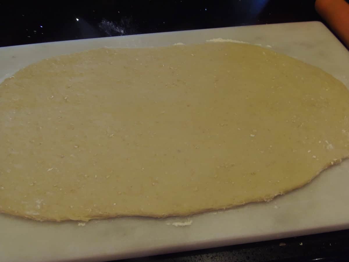 A rectangle of rolled out sweet dough for making sticky buns.