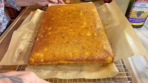 A 9 x 13 cornbread after being lifted from a baking pan and before being cup into squares for serving.
