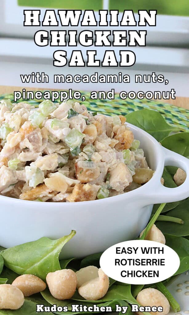 A small white container filled with Hawaiian chicken salad with macadamia nuts and spinach leaves in the foreground.
