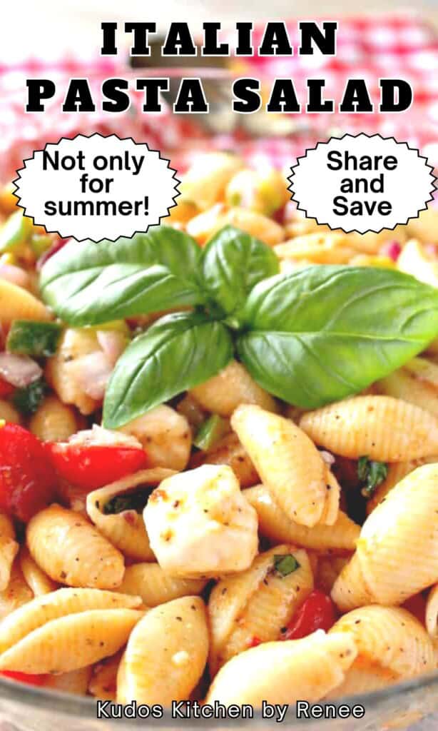 Fresh basil leaves on top of an Italian Pasta Salad with tomatoes and fresh mozzarella balls.
