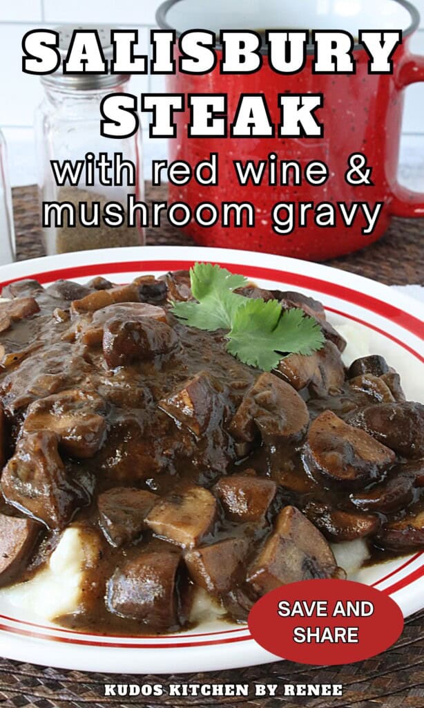 A red and white diner-style plate with a Salisbury steak covered in Red wine and mushroom gravy.