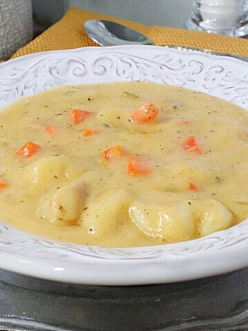Plump potato gnocchi in a bowl of cheddar soup with carrots, celery and bacon.