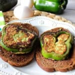 two slices of green pepper filled with avocado and grilled on slices of toast.