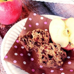 The inside of an applesauce muffin with cinnamon chips on a brown and pink polka dot napkin.