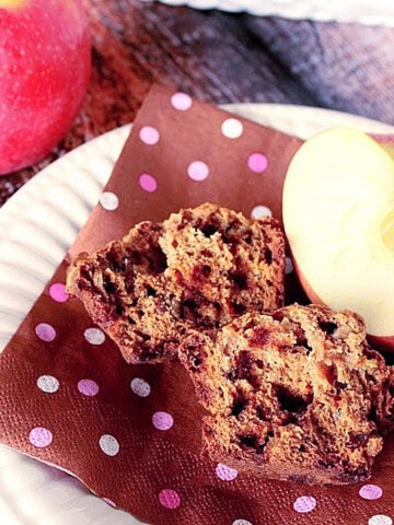 The inside of an applesauce muffin with cinnamon chips on a brown and pink polka dot napkin.