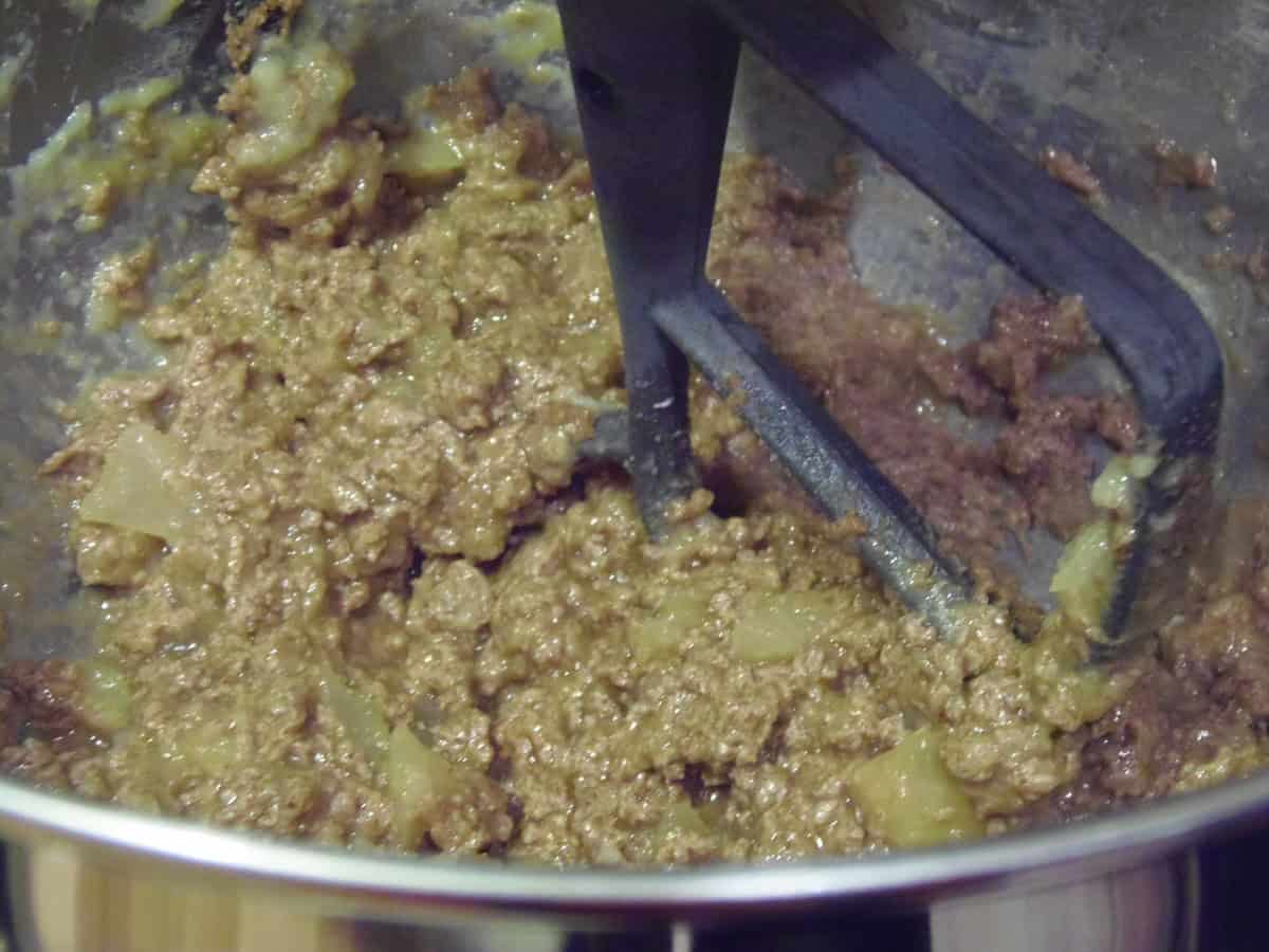 A wet mixture of applesauce and coconut sugar in a stand mixer bowl.