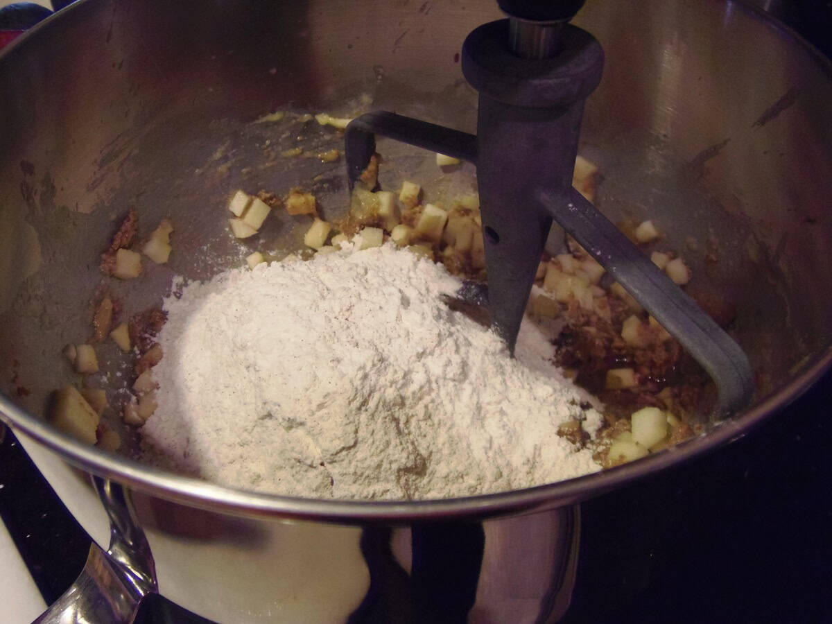 Flour in a bowl of a stand mixer with the paddle attachment.