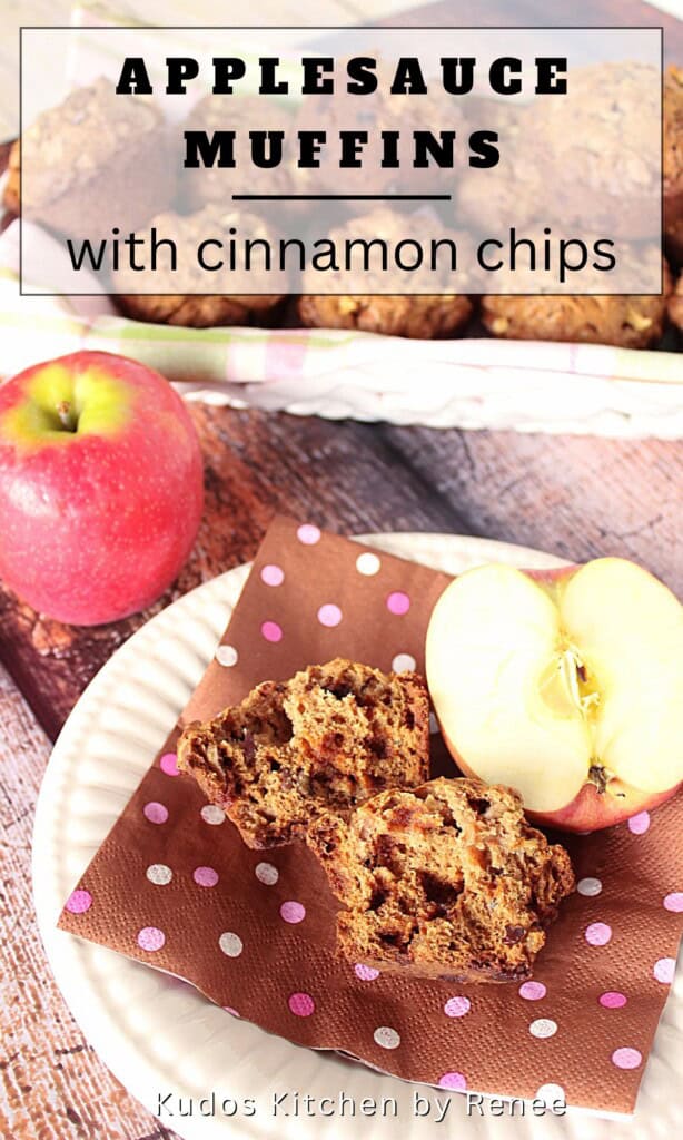 A applesauce muffin that's been cut in half on a plate with a brown napkin.